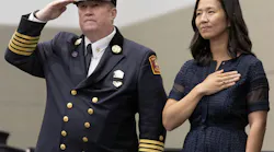 Boston Fire Commissioner Paul Burke and Mayor Michelle Wu stand at a recent fire department graduation ceremony