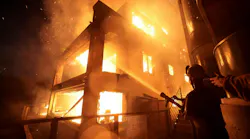 New regulations from the California Board of Forestry and Fire Protection will increase regulations for homes build in wildfire high-risk areas to prevent damage. In this file photo, a firefighter puts water on a burning house during the January 2025 Palisades fire.