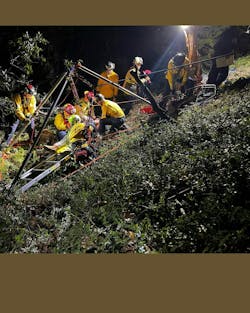 Rescue technicans set up operations to rescue a person who fell into an abandoned mine. Rescue technicans set up operations to rescue a person who fell into an abandoned mine.