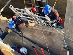 Crews had to place a second shoring panel behind the patient to stop soil from sliding in from his back. The standard panel was too wide for the available space, so it was cut down. Crews had to place a second shoring panel behind the patient to stop soil from sliding in from his back. The standard panel was too wide for the available space, so it was cut down.