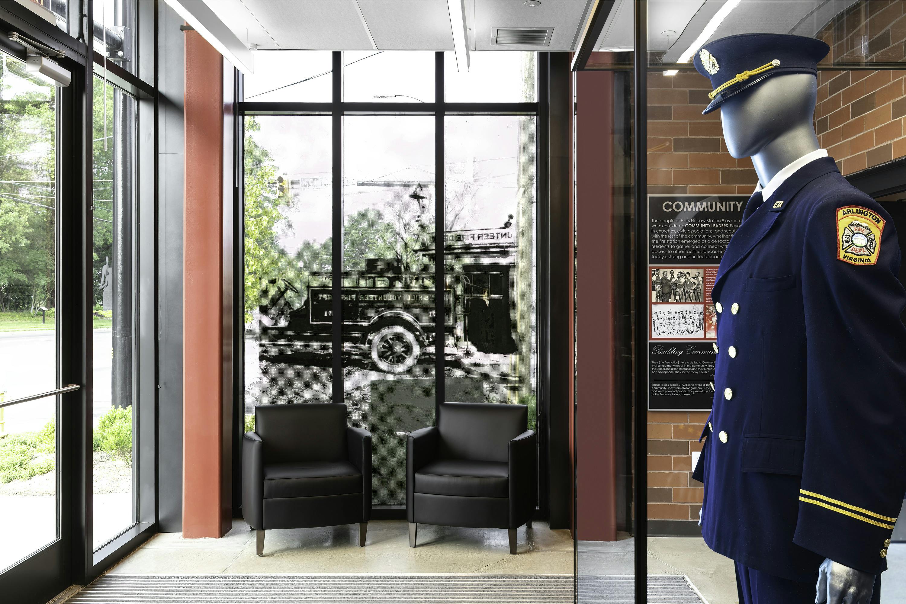The 24/7 lobby of Arlington County, VA, Fire Department Fire Station 8 includes panels that are designed around the six community virtues that emerged from meetings that included members of the community. Artifacts that were donated by the Halls Hill community include a full dress uniform and photographs from family and department archives. An image of the original Halls Hill Volunteer Fire Department water tank aboard the back of its first engine was installed on the glass, so the community can see the fire station and members can see the community through the lens of history.