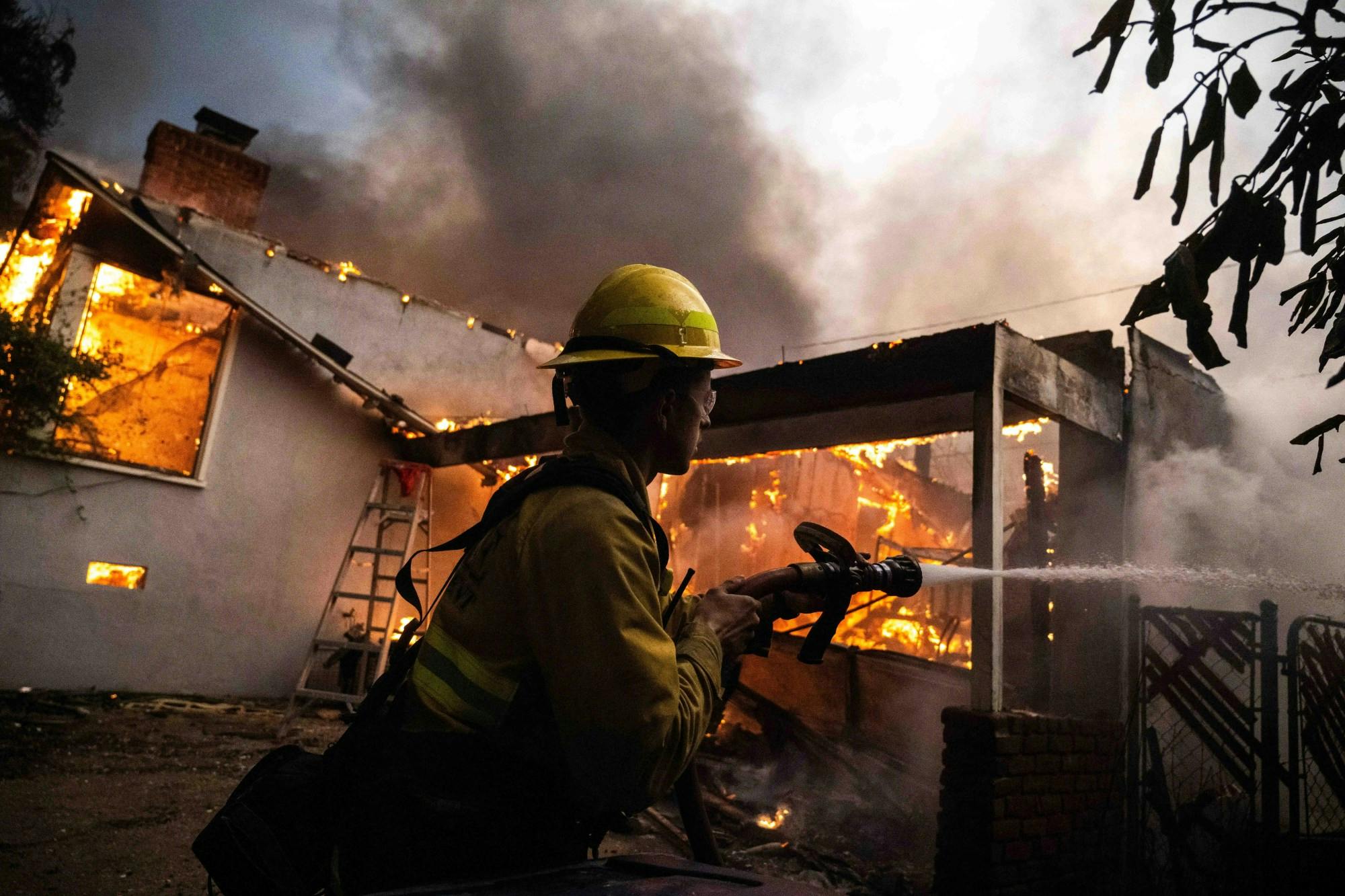 A firefighter tries to battle flames in January.