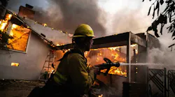A firefighter tries to battle flames in January.