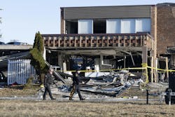 Police pass by the structural damage caused by an explosion and fire at the Bristol nursing home Tuesday. Police pass by the structural damage caused by an explosion and fire at the Bristol nursing home Tuesday.