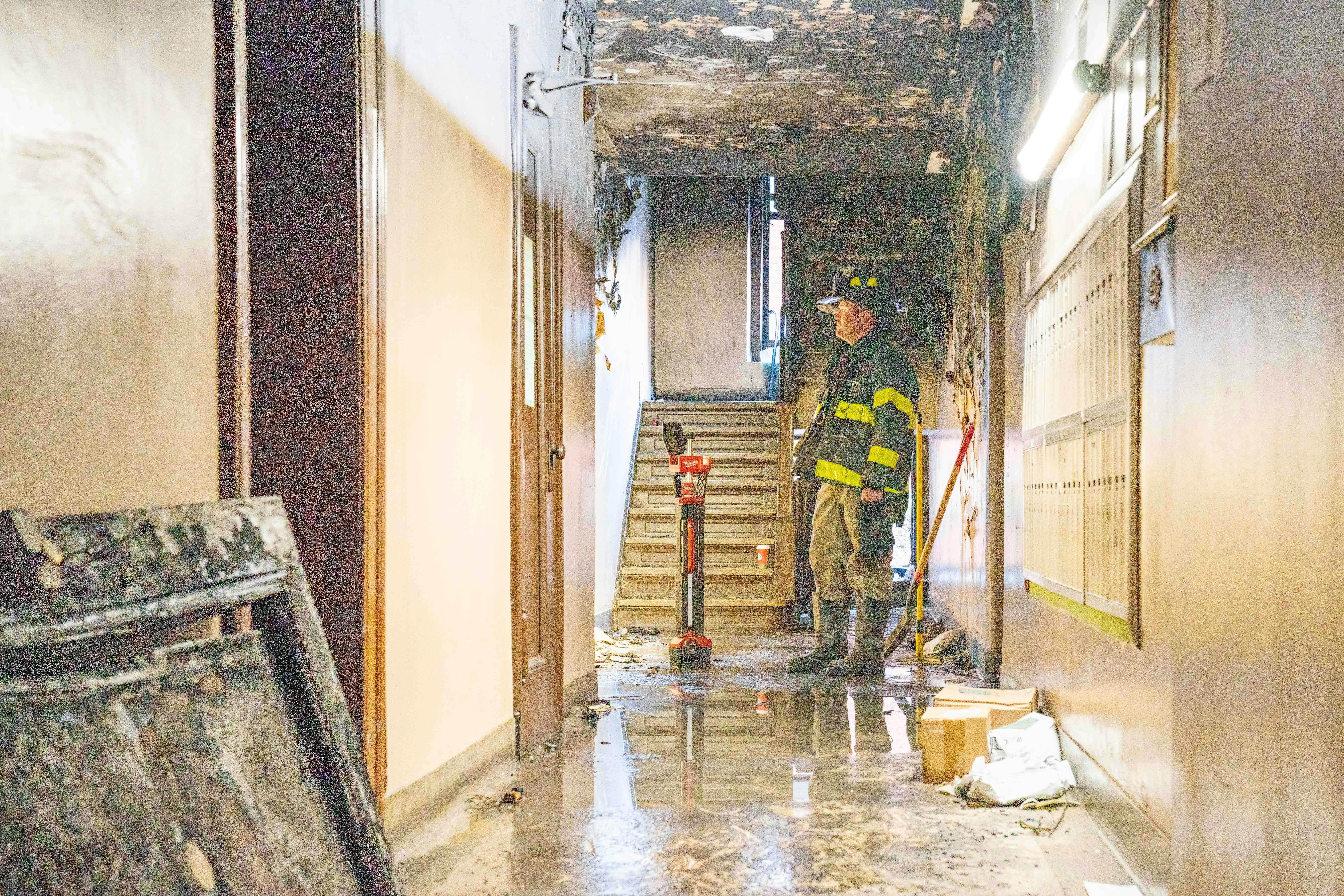 An FDNY investigator examines the scene where an 80-year-old victim died this month.