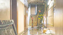 An FDNY investigator examines the scene where an 80-year-old victim died this month.