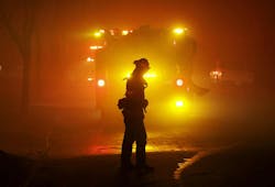 A firefighter turns as smoke is blown down on them while providing structure protection in Altadena, CA, on Jan. 7, 2025. A firefighter turns as smoke is blown down on them while providing structure protection in Altadena, CA, on Jan. 7, 2025.