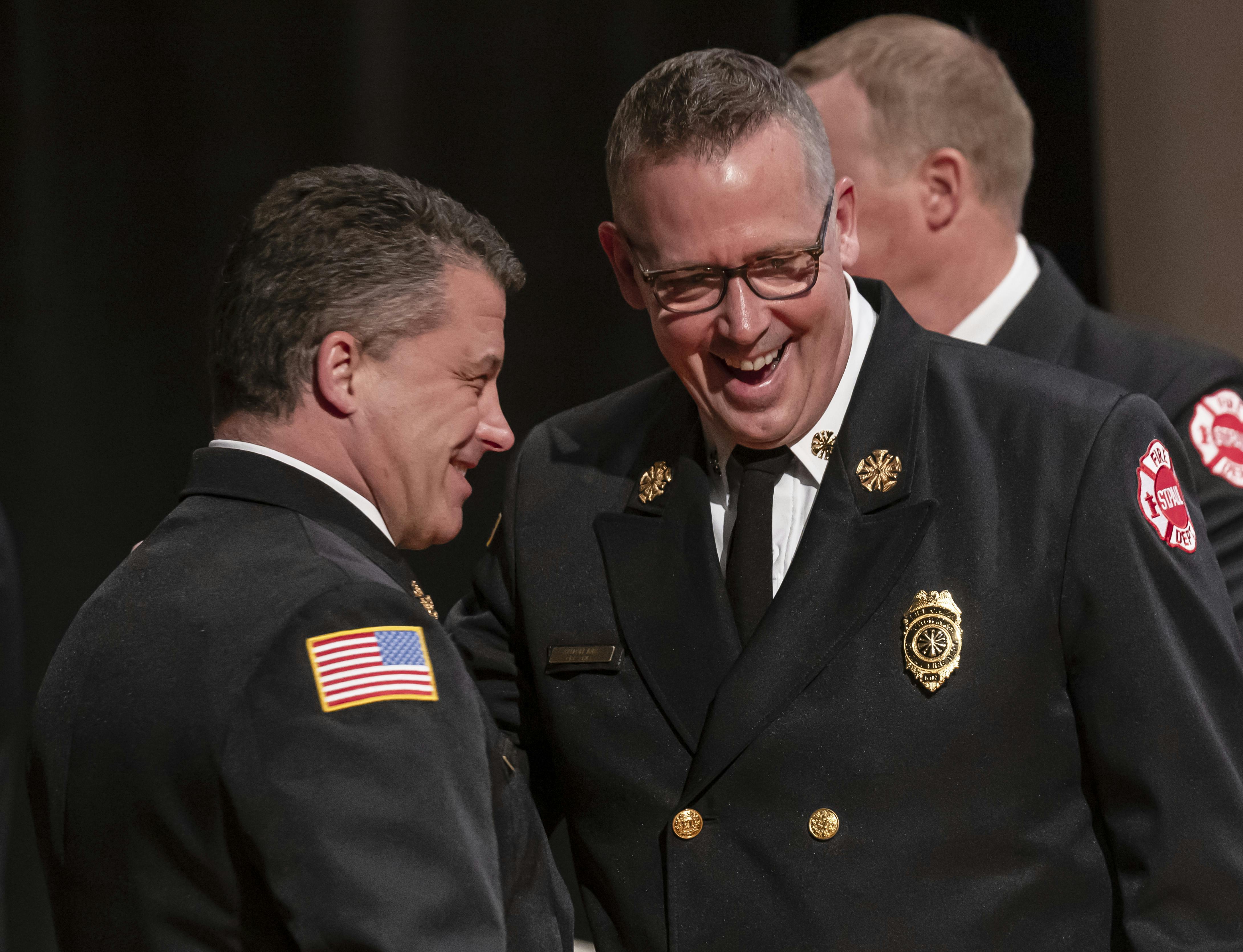 St. Paul Fire Chief Butch Inks, right, shares a laugh with Assistant Chief Anthony Farina before the start of the St. Paul Fire Academy Class of 2025-B graduation ceremony last month.
