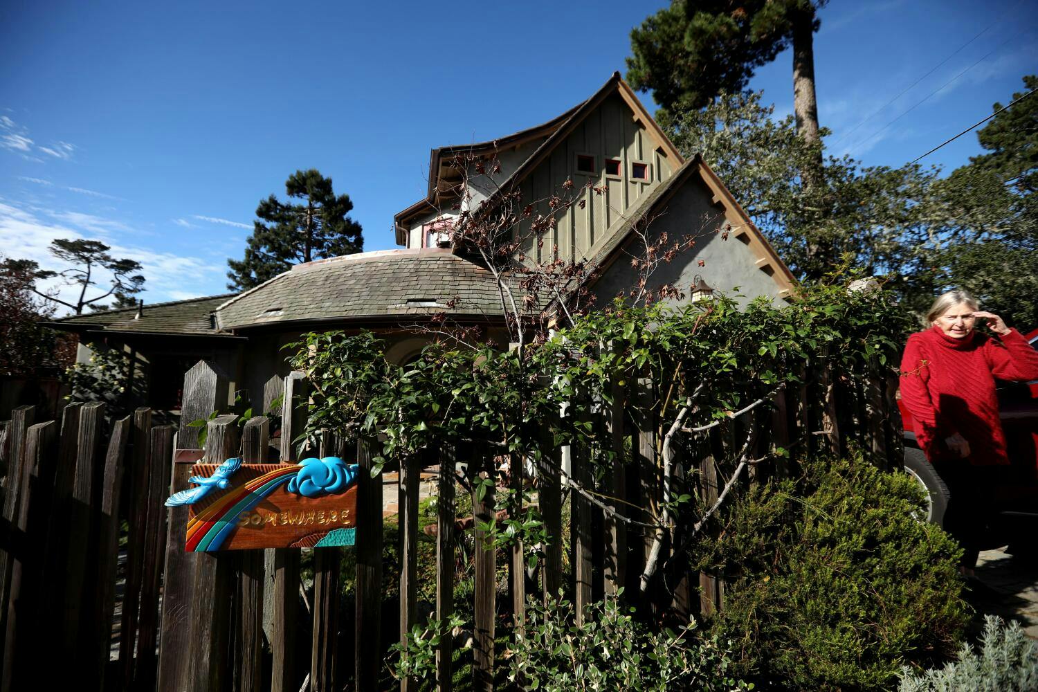 A woman sits outside her house 'Somewhere' in Carmel-by-the-Sea.