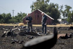 Fire investigators examine debris from the Devastating Pyrotechnics explosion in a nearby field in Esparto on July 21, 2025, Fire investigators examine debris from the Devastating Pyrotechnics explosion in a nearby field in Esparto on July 21, 2025,