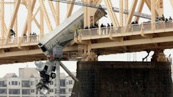 The scene at the first of two accidents where tractor-trailer cabs were left hanging over the Ohio River from a bridge. The scene at the first of two accidents where tractor-trailer cabs were left hanging over the Ohio River from a bridge.