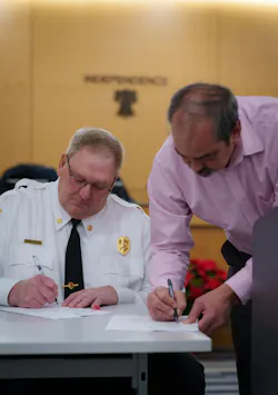 The mayor of Independence, MN, signing documents to be a part of the West Suburban Fire District. The mayor of Independence, MN, signing documents to be a part of the West Suburban Fire District.