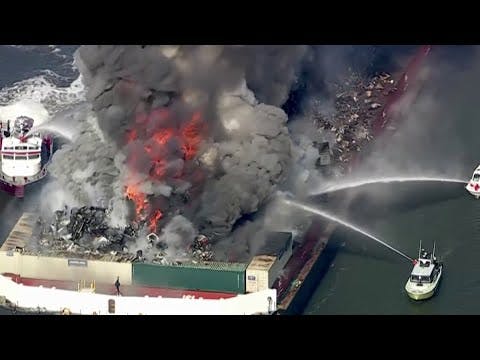 Fire crews work to put out fire in barge on Delaware River in Del