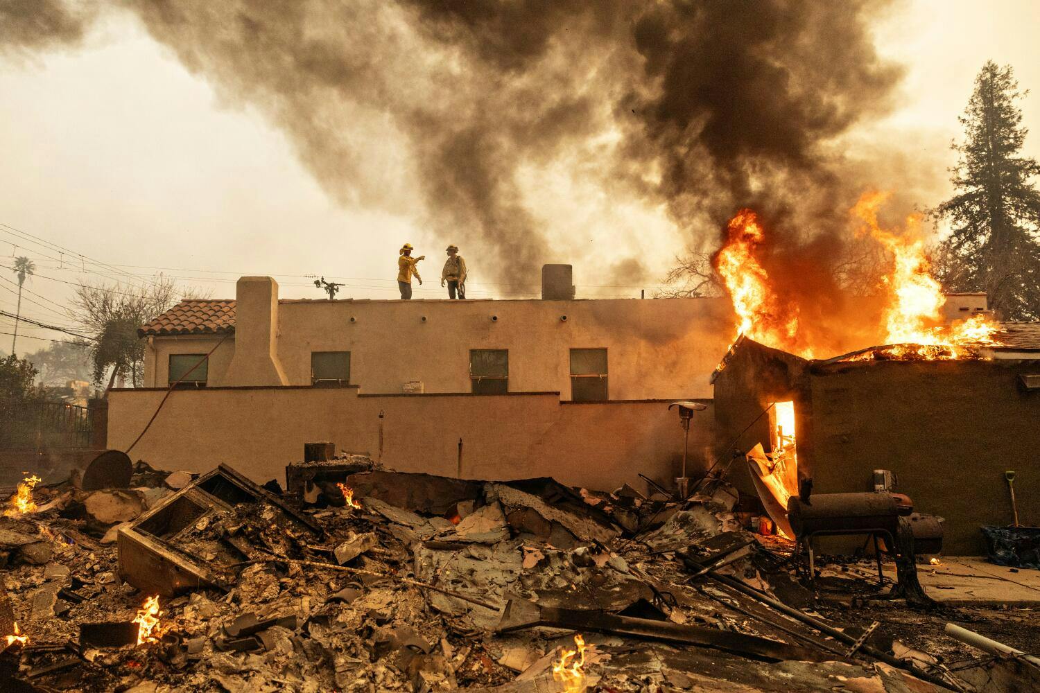 Firefighters work during Eaton fire on Jan. 8, 2025 in Altadena, CA.