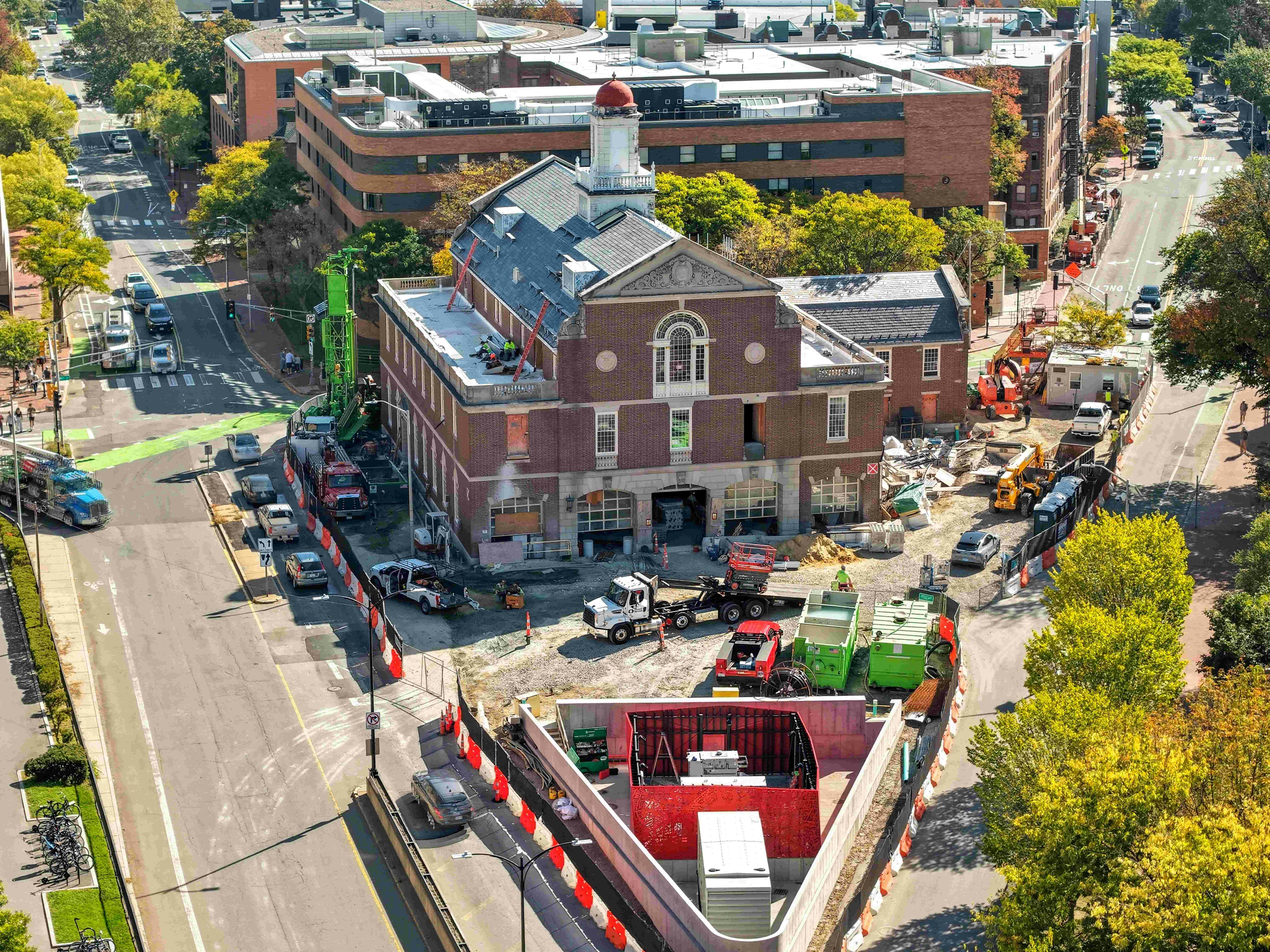 The renovation of the Cambridge, MA, Fire Department Headquarters had to comply with the city&rsquo;s requirement that all nonresidential construction project had to be all-electric and Net Zero. A full substation had to be built on headquarters property (foreground). Instead of opting for the initial premise of the substation being wrapped in chain link fence, a decorative red steel enclosure that is reminiscent of the department&rsquo;s response district was employed.