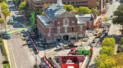 The renovation of the Cambridge, MA, Fire Department Headquarters had to comply with the city’s requirement that all nonresidential construction project had to be all-electric and Net Zero. A full substation had to be built on headquarters property (foreground). Instead of opting for the initial premise of the substation being wrapped in chain link fence, a decorative red steel enclosure that is reminiscent of the department’s response district was employed. The renovation of the Cambridge, MA, Fire Department Headquarters had to comply with the city’s requirement that all nonresidential construction project had to be all-electric and Net Zero. A full substation had to be built on headquarters property (foreground). Instead of opting for the initial premise of the substation being wrapped in chain link fence, a decorative red steel enclosure that is reminiscent of the department’s response district was employed.