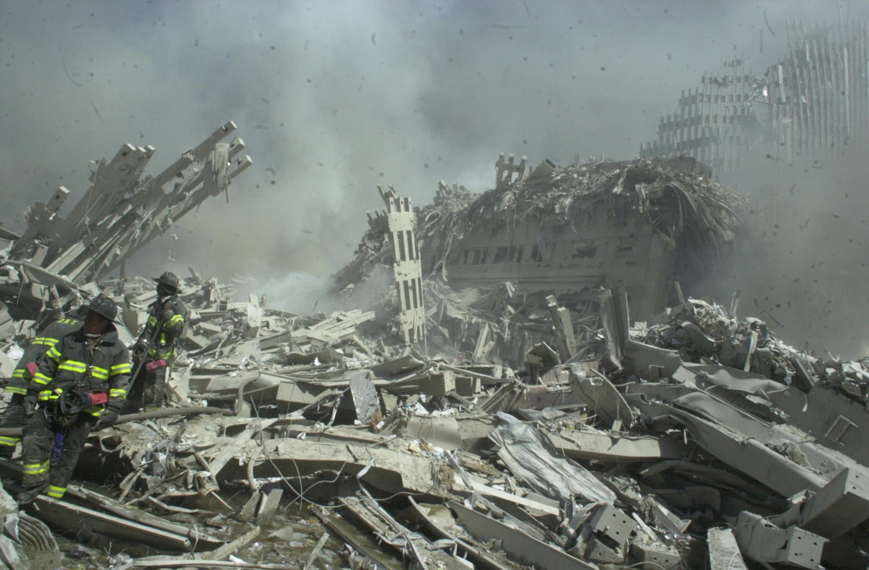 Firefighters search debris in the ruins of the World Trade Center on Sept. 12.
