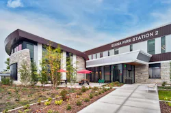 The side entrance of the ECHSC connects the main lobby to the parking area and a large outdoor patio and seating area. The latter is designed as a welcoming space to draw pedestrians into the site or to host small community gatherings. The side entrance of the ECHSC connects the main lobby to the parking area and a large outdoor patio and seating area. The latter is designed as a welcoming space to draw pedestrians into the site or to host small community gatherings.