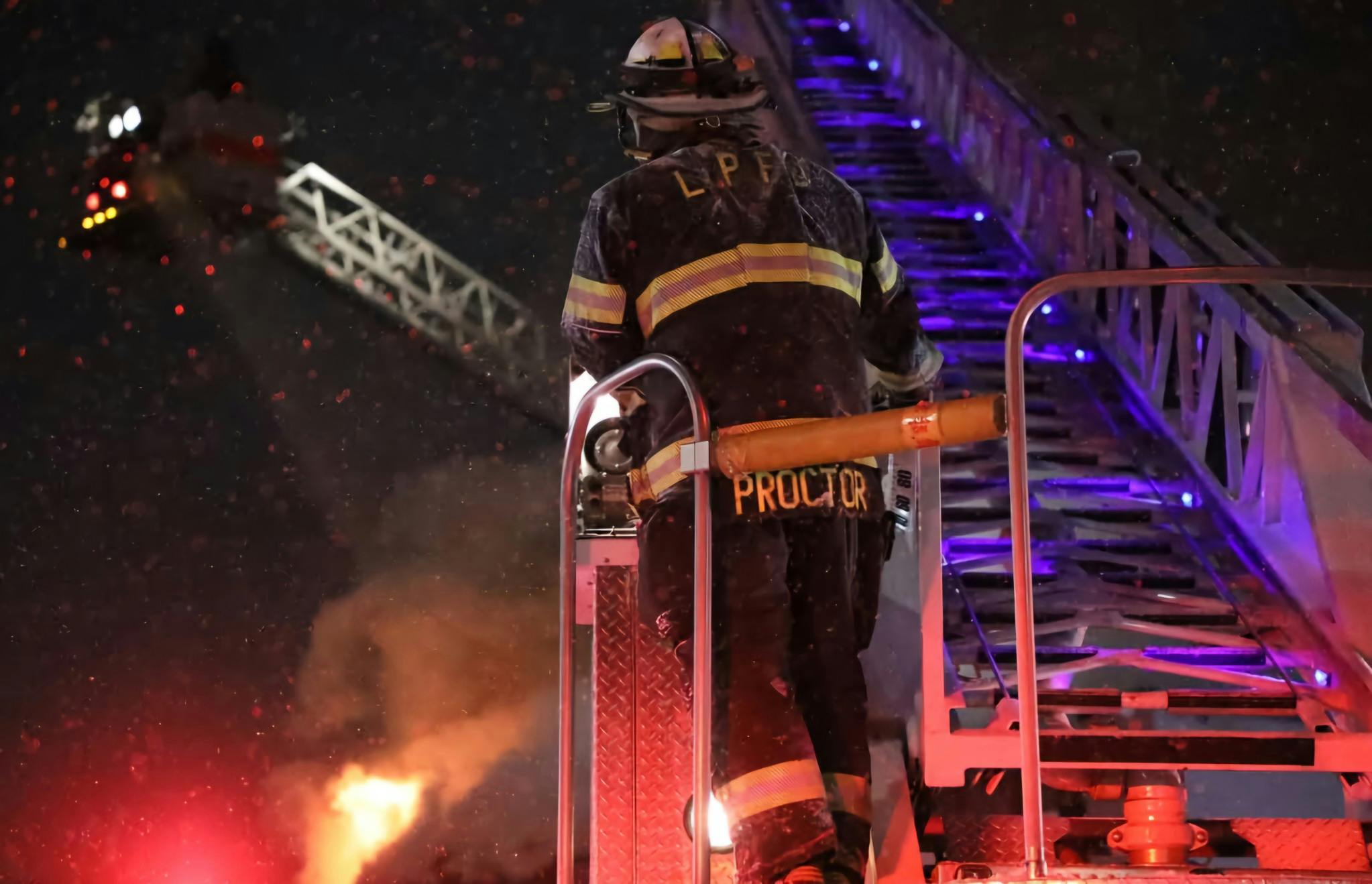 firefighter on aerial ladder