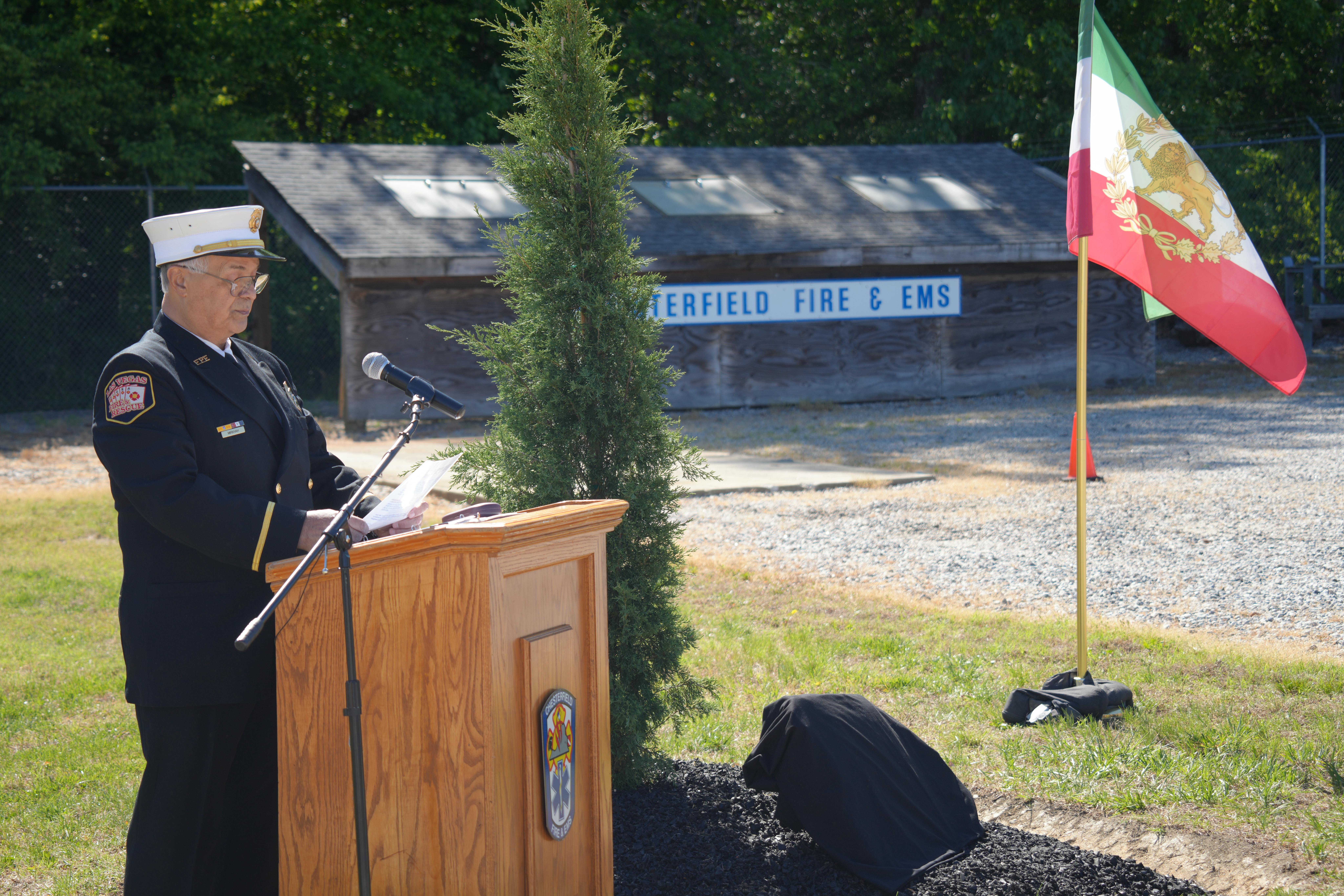 Ozzie Mirkhah speaks during a service honoring the ultimate sacrifice of an Iranian firefighter.