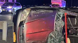 crashed automobile on its side amid moving traffic crashed automobile on its side amid moving traffic
