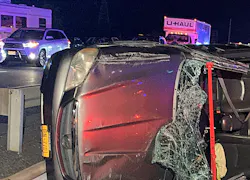 crashed automobile on its side amid moving traffic crashed automobile on its side amid moving traffic