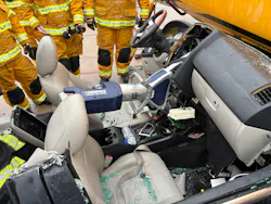 hydraulic spreader in position to displace dashboard of a crashed vehicle to rescue victim hydraulic spreader in position to displace dashboard of a crashed vehicle to rescue victim