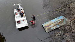 Photos by Robert Policht firefighters conducting a search at edge of a body of water