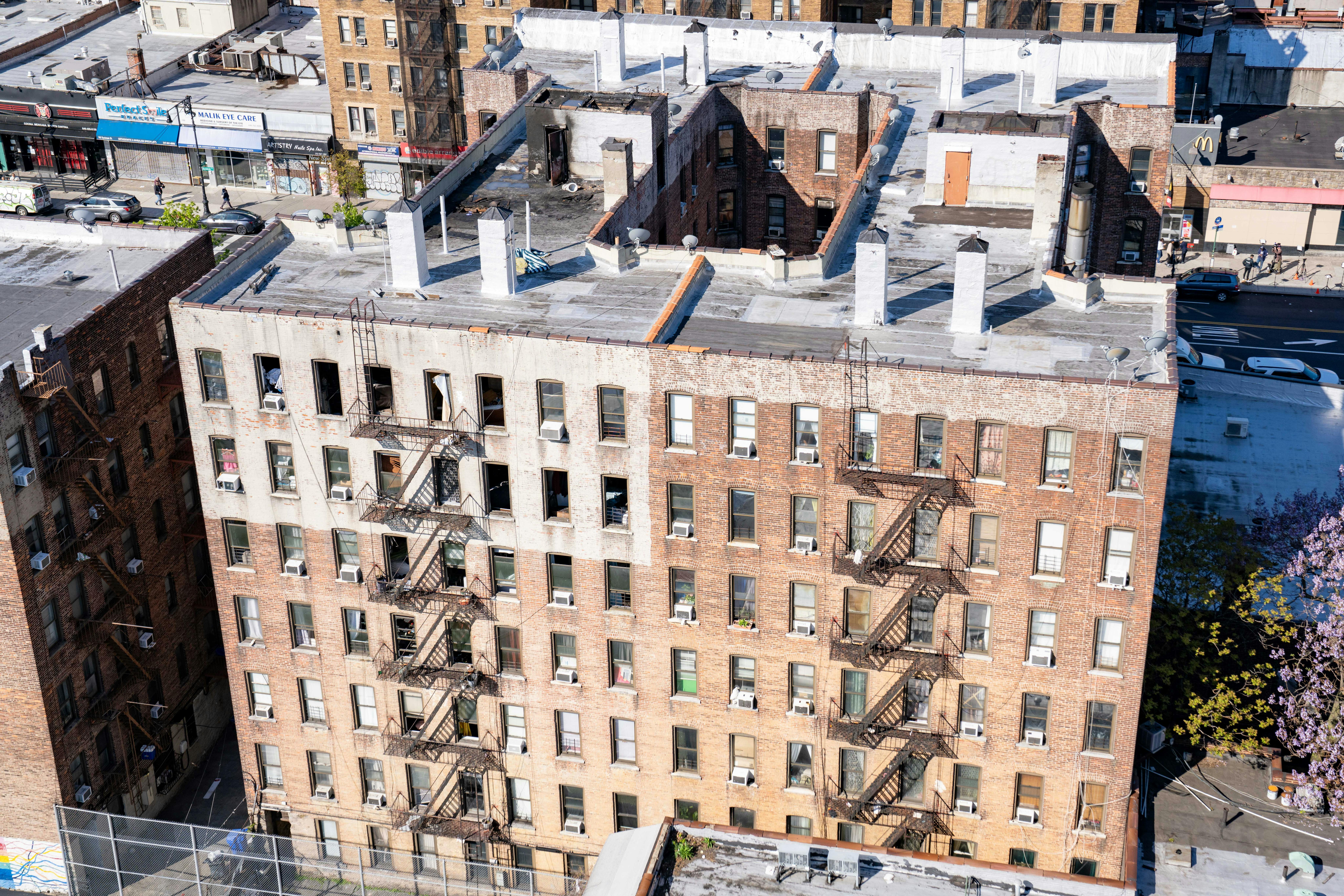 The owners of an apartment building in Manhattan where there people died are being sued by New York City for neglecting fire hazards at a neighboring property.