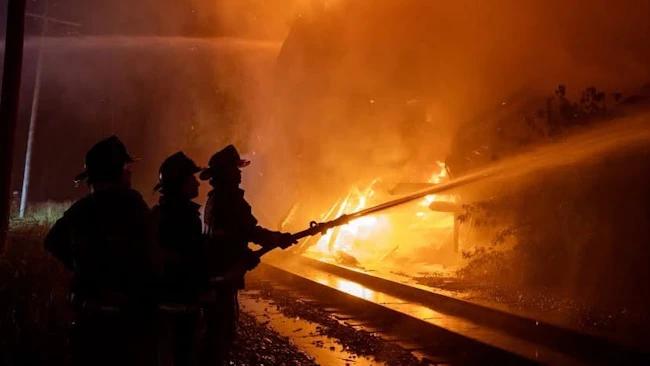 firefighters operating hoseline at fire