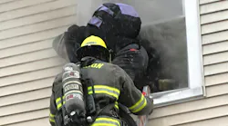firefighter on ground ladder at second-floor window of house rescuing occupant firefighter on ground ladder at second-floor window of house rescuing occupant