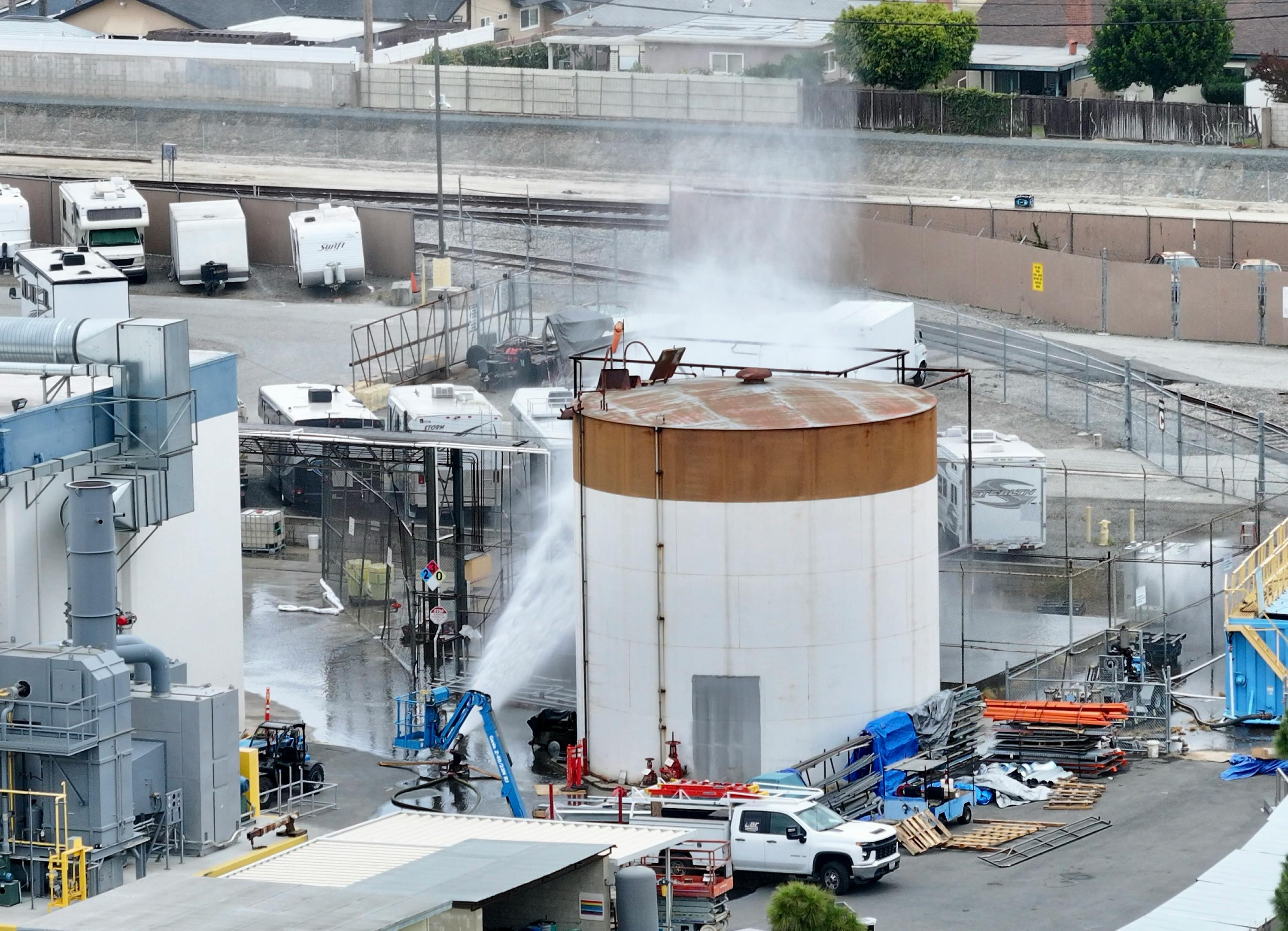 Water is sprayed on a 34,000-gallon tank that overheated at GKN Aerospace in Garden Grove, CA.