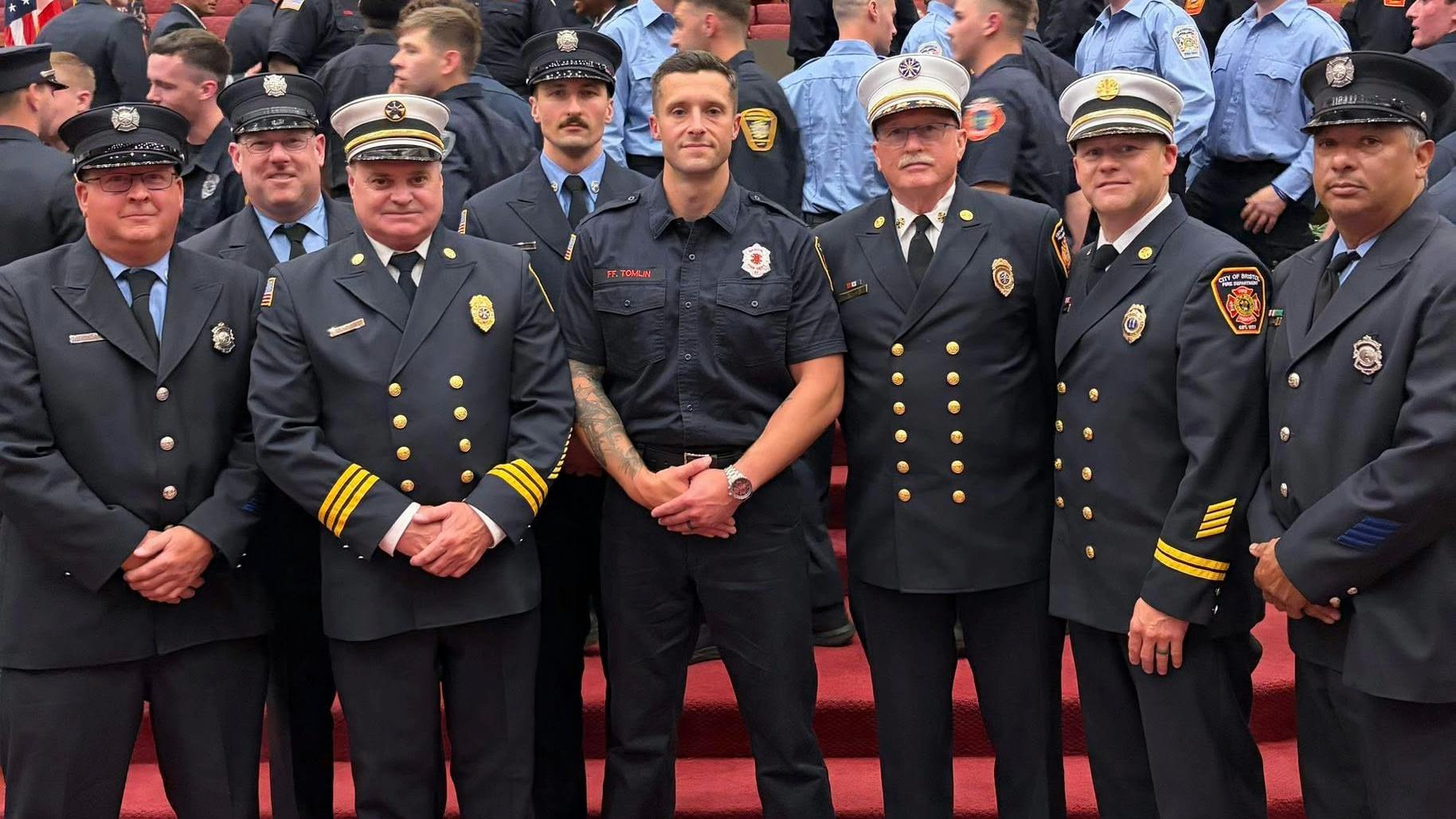 Justin Tomlin (center) following his graduation from the Connecticut Fire Academy. He served in the U.S. Army in both Iraq and Afghanistan before joining law enforcement but entered the fire service at age 41.