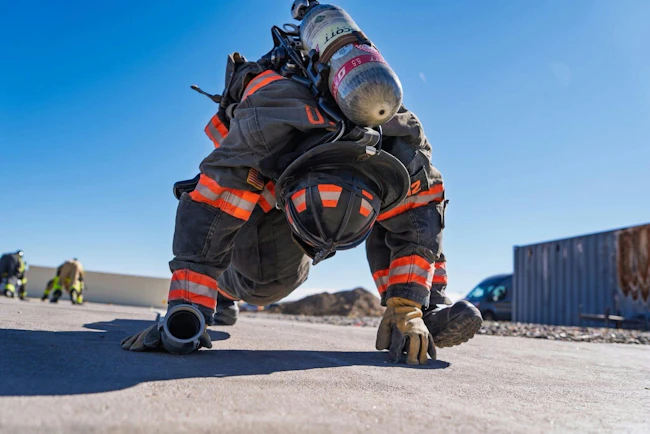 firefighter working out in full firefighting gear