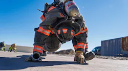 firefighter working out in full firefighting gear