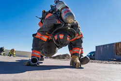 firefighter working out in full firefighting gear