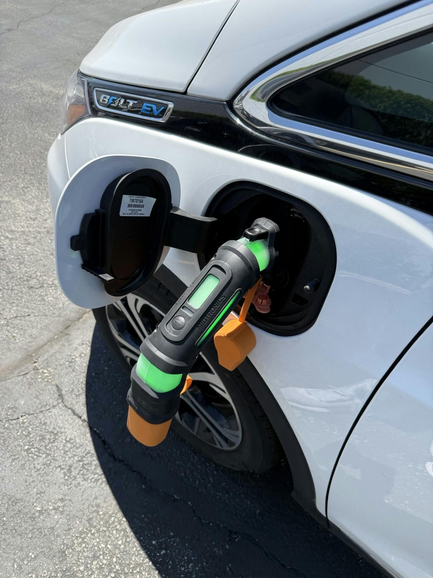 Midtronics xIM-100 EV Immobilizer device inserted into electric vehicle charging port