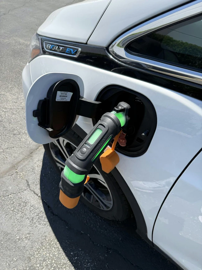 Midtronics xIM-100 EV Immobilizer device inserted into electric vehicle charging port