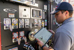 fire engine pump operator using digital platform on laptop to check mission readiness