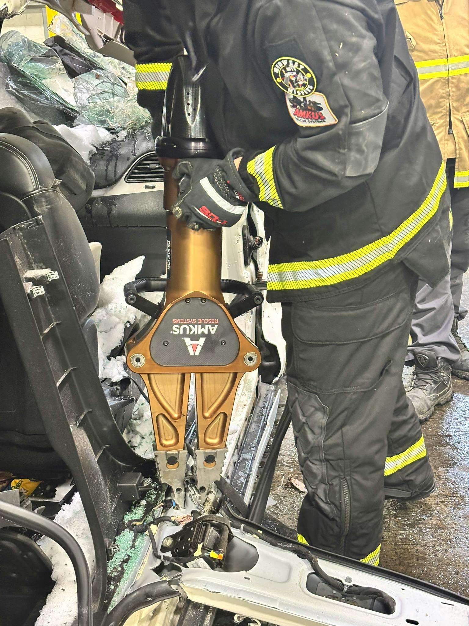 firefighter used battery-powered spreader during vehicle extrication training