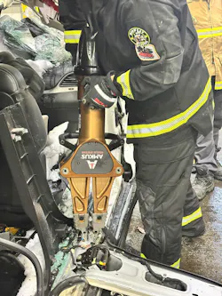 firefighter used battery-powered spreader during vehicle extrication training