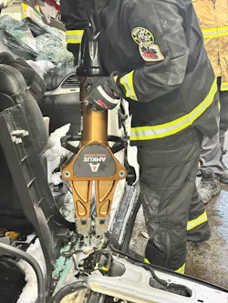 firefighter used battery-powered spreader during vehicle extrication training