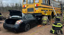 firefighters training scenario involving school bus on top of automobile