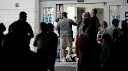 Philadelphia officials gather at the entrance of Penn Presbyterian Medical Center, where three Philadelphia police officers were taken after being shot by a retired firefighter.