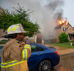fire department officer on scene of house fire communicating via radio