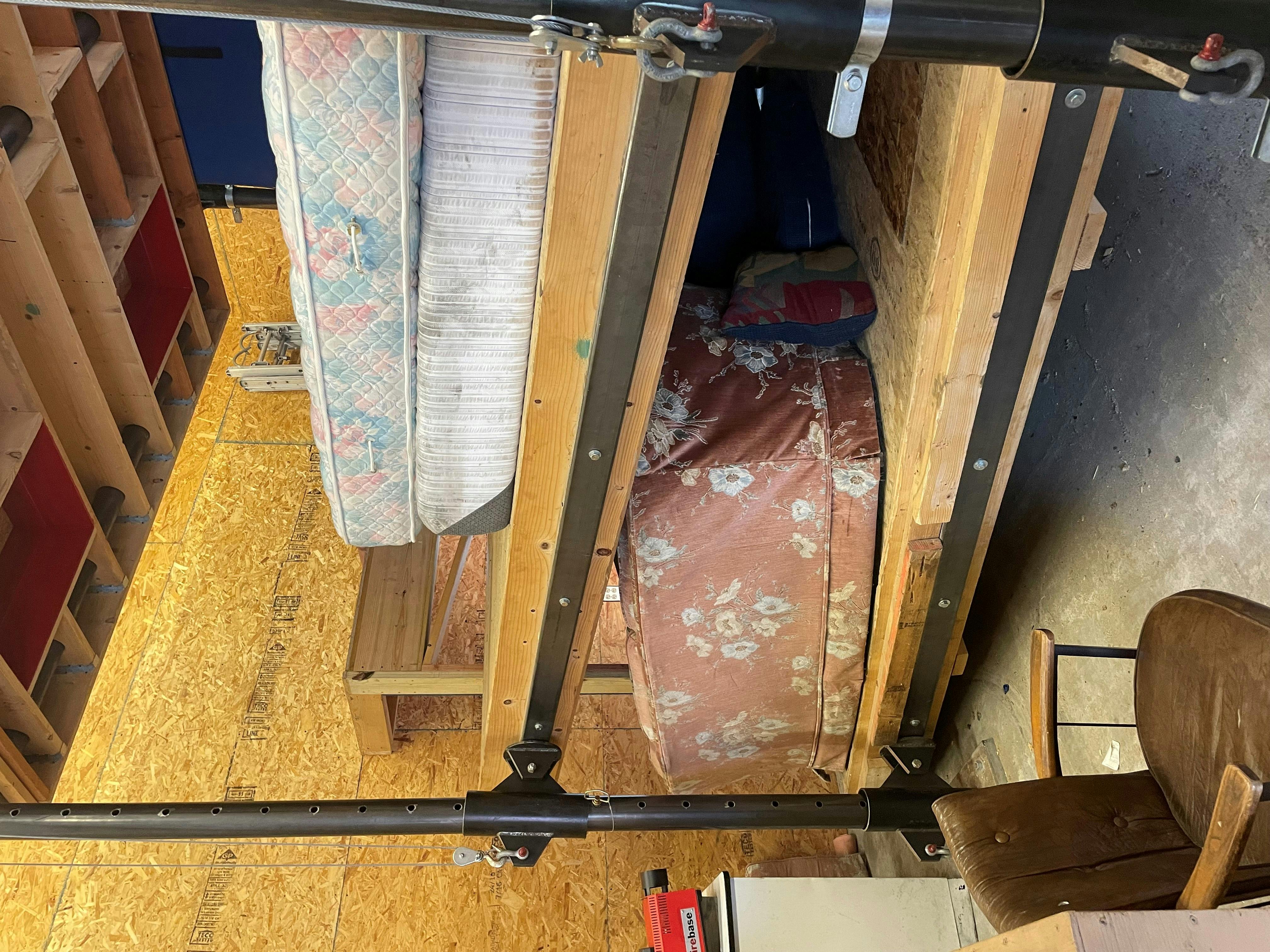 training prop of structural building collapse with upper floor slanted and resting on a manikin