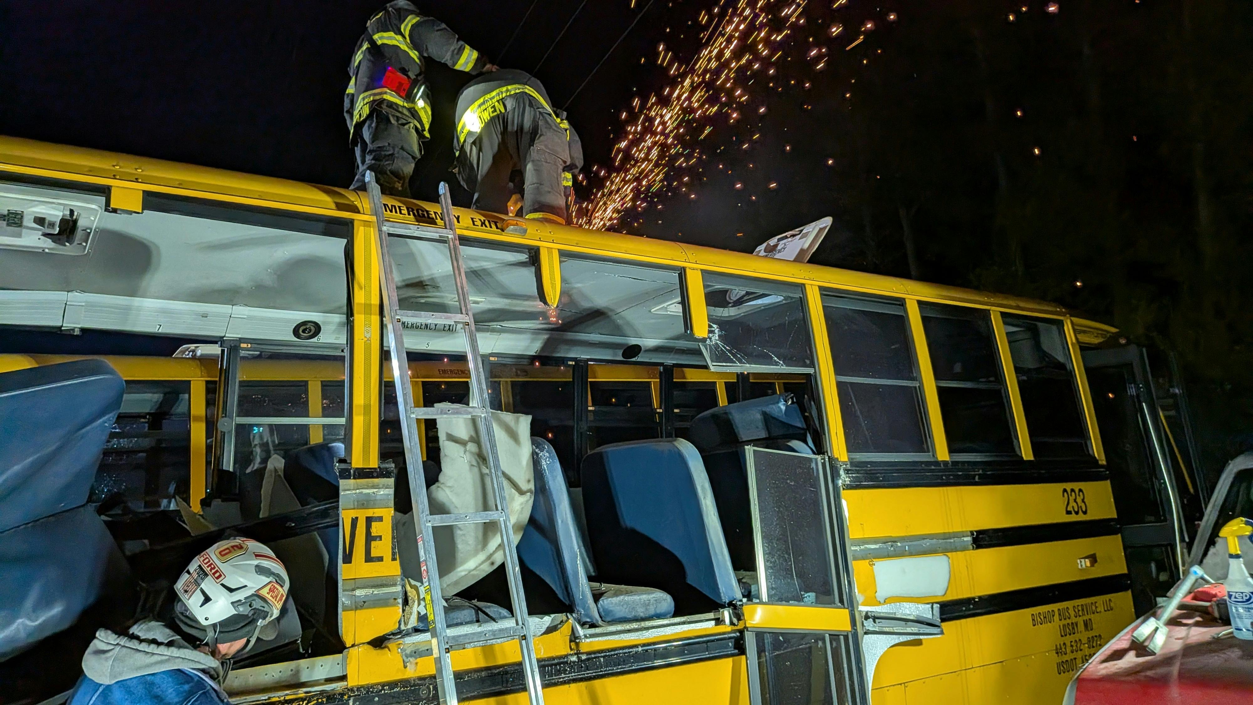 firefighters training on rescue techniques on school bus