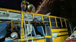 firefighters training on rescue techniques on school bus