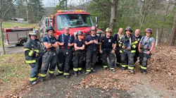 fire department members standing in front of a fire vehicle