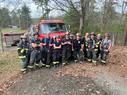 fire department members standing in front of a fire vehicle